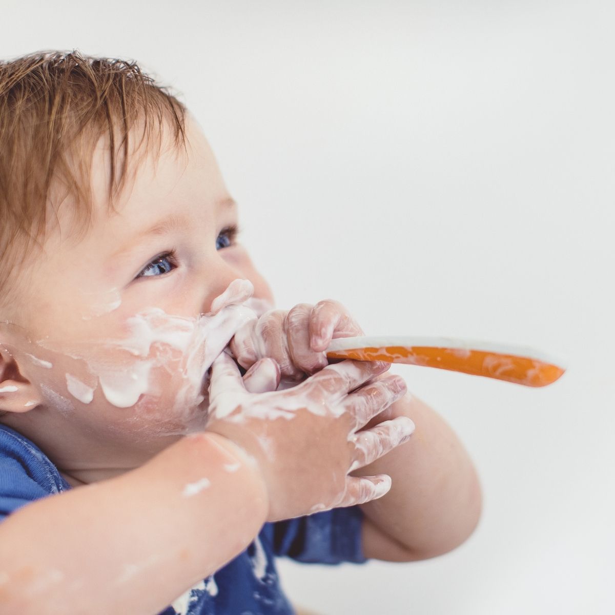 baby feeding from a spoon